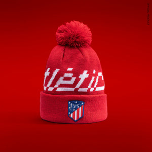 Atletico Madrid Pixel Beanie on a red background.